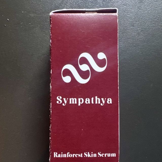 The Sympathya Rainforest Skin Serum box, deep red with the white mark